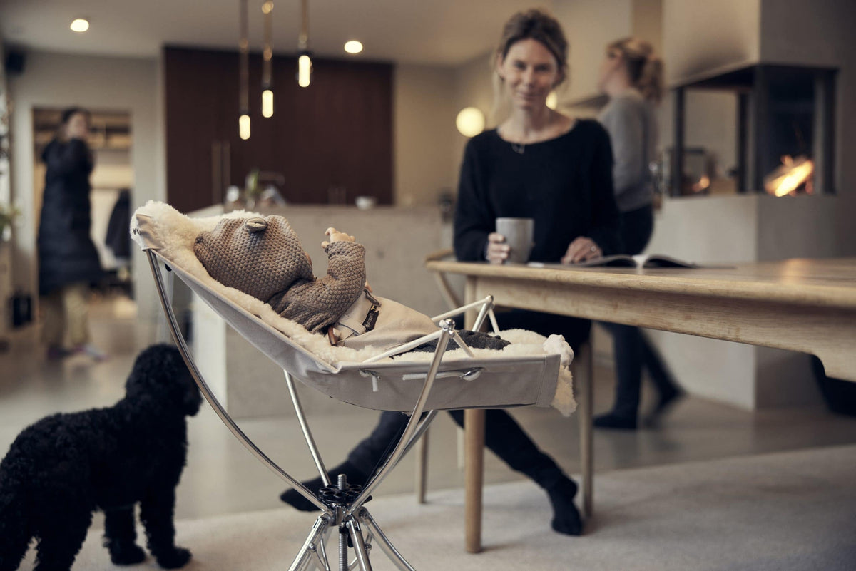 Baby resting in the Vaggaro bouncer in a family kitchen